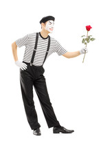 Full Length Portrait Of A Male Mime Artist Giving A Rose Flower