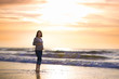 © famveldman - Silhouette of a young pregnant woman with a sunset at a beach