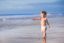 Funny Little Baby Girl Running On A Beautiful Tropical Beach