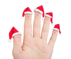 Fingers faces in Santa hats. Happy family celebrating concept fo