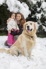 Wall Mural - Family with a dog at snow