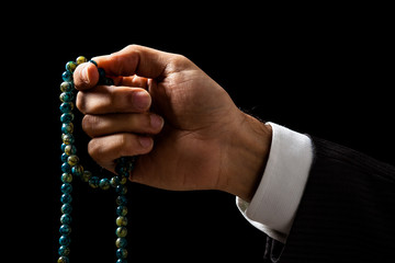 Wall Mural - Hand Holding a Tasbih, a Muslim Rosary