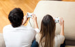 © Minerva Studio - Young couple playing video games at home