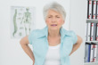 © lightwavemedia - Senior woman with back pain in medical office