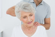 © lightwavemedia - Male physiotherapist massaging a senior woman's neck