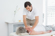 © lightwavemedia - Physiotherapist massaging a senior woman's shoulder