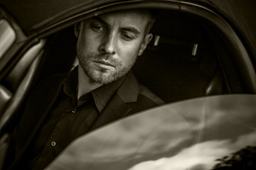 Elegant young handsome man and convertible car.