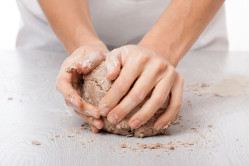 hands knead rye dough