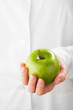 green apple in hand, white background