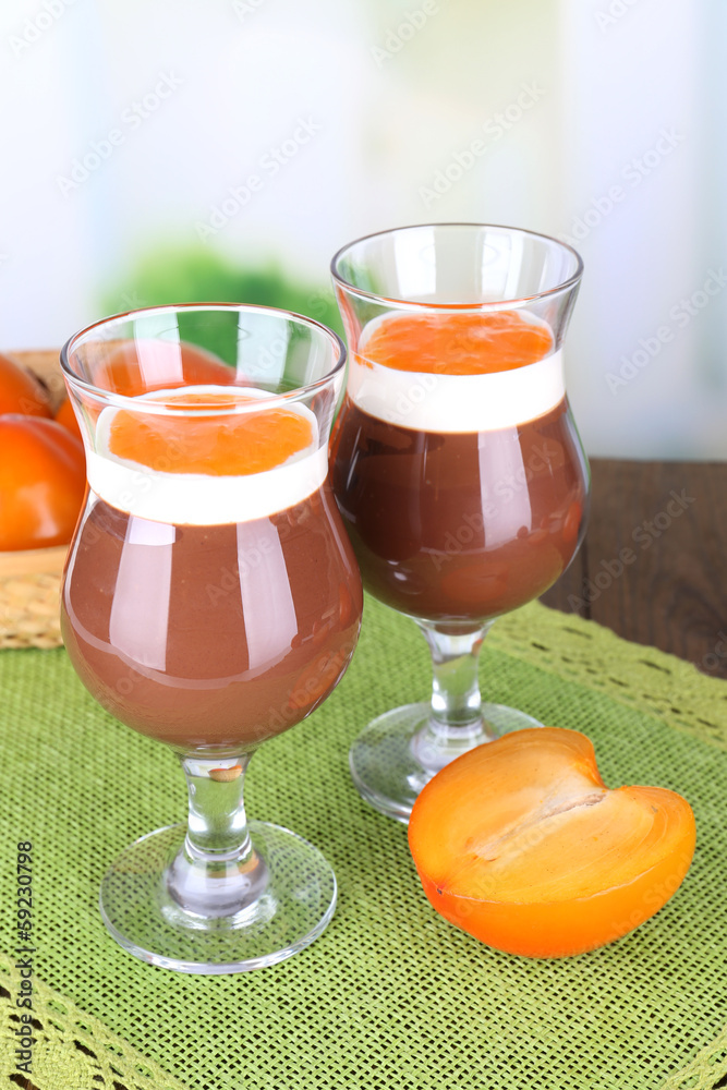 Dessert of chocolate and persimmon on table on light background