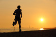 © Antonioguillem - Backlight of a man running on the beach at sunset