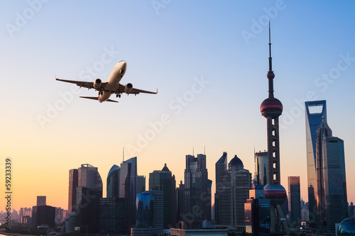 Fototapeta do kuchni modern city skyline with airplane