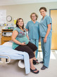 © Tyler Olson - Female Nurses With Pregnant Woman In Hospital Room