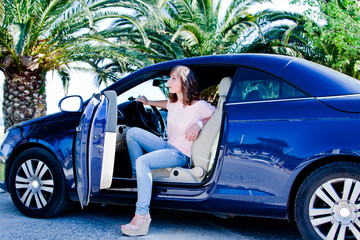 young and beautiful woman driving a car