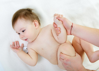 massage of cute smiling baby girl