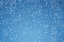 Falling Snow Over Blue Background With Copy Space