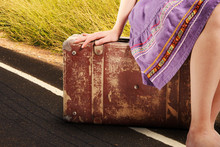 Woman With Old Vintage Suitcase On The Road