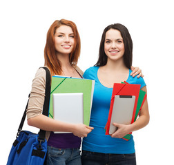 Wall Mural - two smiling students with bag, folders and tablet