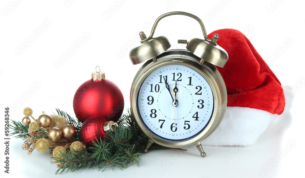 Alarm clock with Santa hat and Christmas decorations isolated