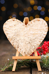 Wall Mural - Decorative heart on easel, on wooden table, on shiny background