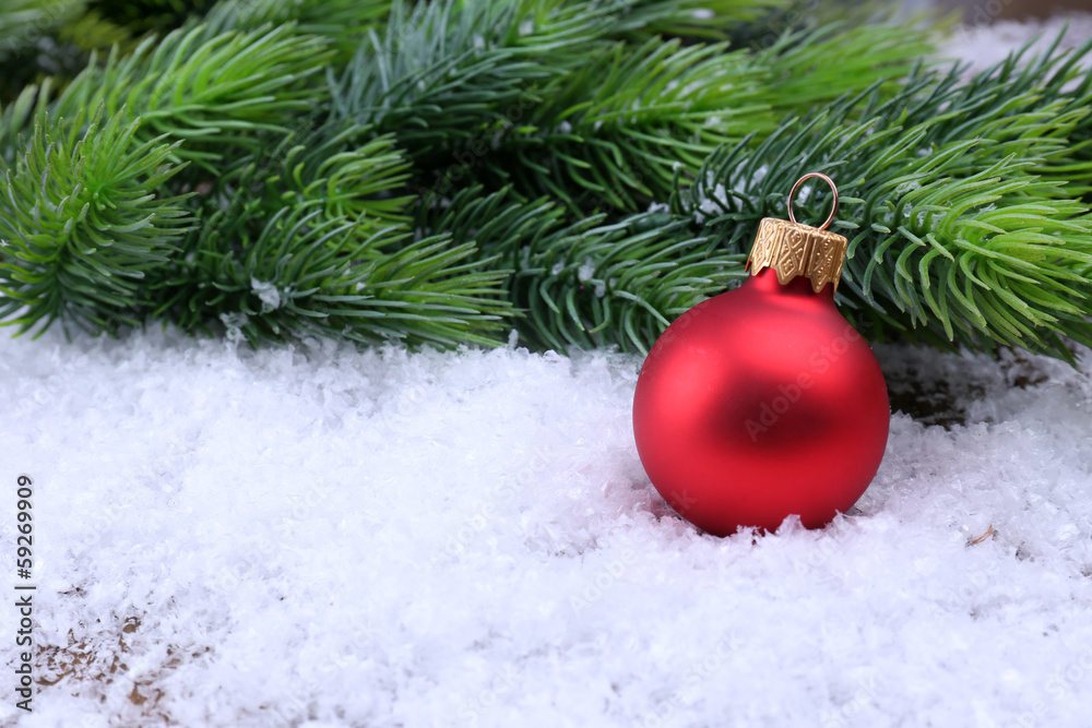 Christmas ball and fir tree on light background