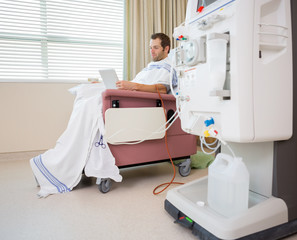 Wall Mural - Patient Using Digital Tablet at Dialysis Center