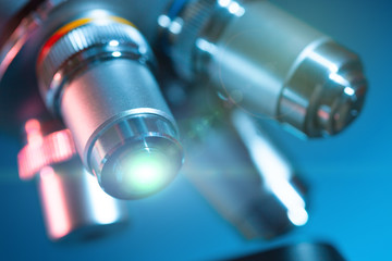 Sticker - microscope lens with a beam of green light