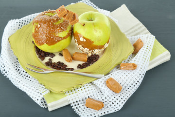 Homemade taffy apples, on napkin, on wooden background