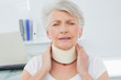 © lightwavemedia - Senior woman wearing cervical collar in medical office