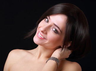 Beautiful smiling woman with fashion watch on hand on black