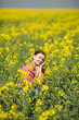 © GTeam - Young beautiful woman in flowering field in summer. Outdoors