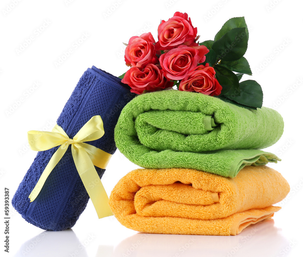 Colorful towels and flowers, isolated on white