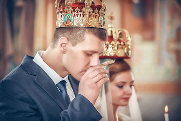 Wall Mural - Bride and groom at the church during a wedding ceremony