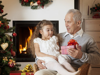 Happy little girl getting Christmas present