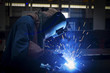 © Sasint - worker with protective mask welding metal