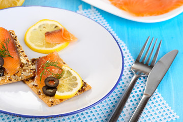 Sticker - Salmon sandwiches on plate  on wooden table close-up