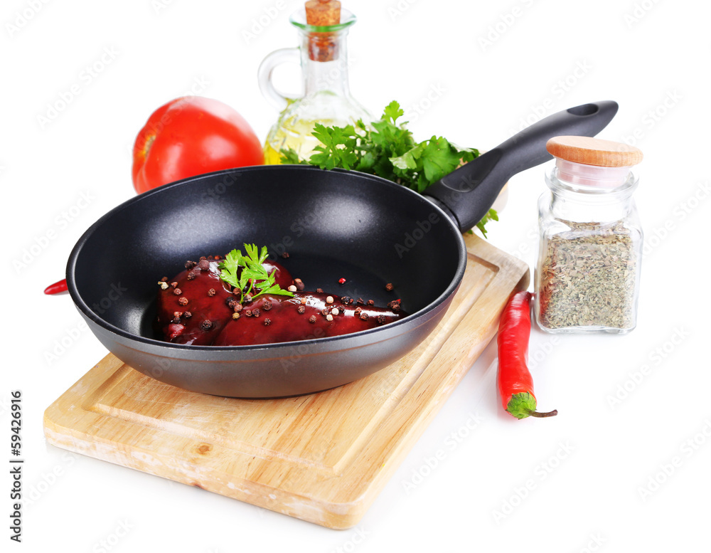 Raw liver in pan with spices and condiments isolated on white