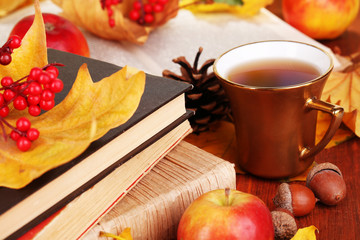 Fototapete - Books and autumn leaves on wooden table close-up