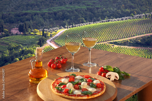 Obraz w ramie Italian pizza and glasses of white wine in Chianti, Italy