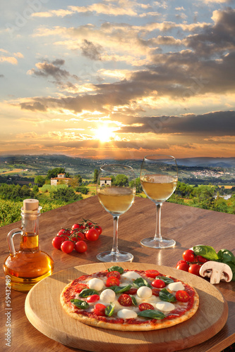 Naklejka ścienna Italian pizza and glasses of white wine in Chianti, Italy