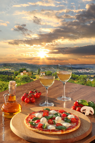 Naklejka dekoracyjna Italian pizza and glasses of white wine in Chianti, Italy