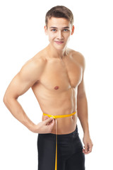 Wall Mural - Young man measuring waist