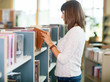 © Tyler Olson - Student Choosing Book In Bookstore