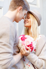 Wall Mural - happy couple with flowers in the city