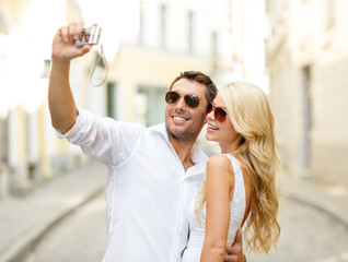 Canvas Print - travelling couple taking photo picture with camera