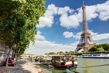 Wall Mural - Seine river overlooking Eiffel Tower in sky, Paris, France. Summer view of city center.