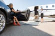Leinwandbild Motiv Wealthy Woman Stepping Out Of Car At Terminal