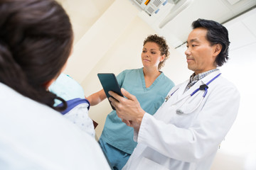 Wall Mural - Medical Team With Female Patient In Examination Room