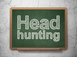 Business concept: Head Hunting on chalkboard background