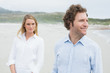 © lightwavemedia - Smiling casual young couple at beach